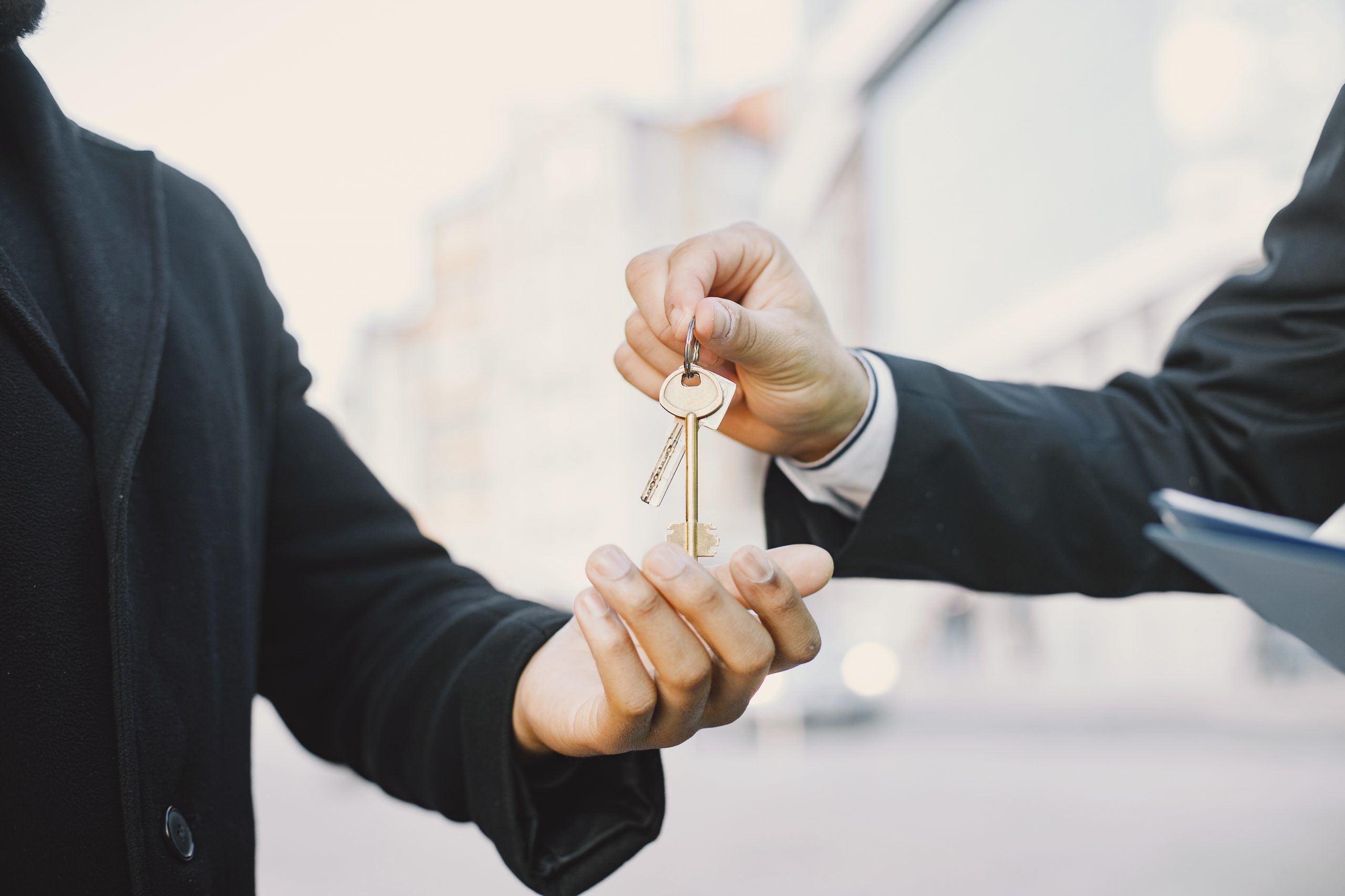 Property management handing keys to the agent