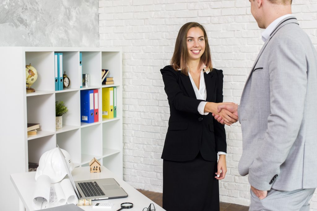 Woman shaking hands with man